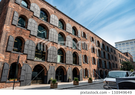 New york, usa august 15,2024. Empire stores historic brick warehouse building in dumbo, brooklyn, new york city, featuring characteristic arched windows and cobblestone street New york, usa august 15,2024. Empire stores historic brick warehouse building in dumbo, brooklyn, new york city, featuring characteristic arched windows and cobblestone street 138949649