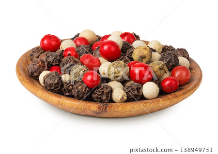 Pepper mix in a wooden bowl isolated on white background. Pepper mix in a wooden bowl isolated on white background. 138949731