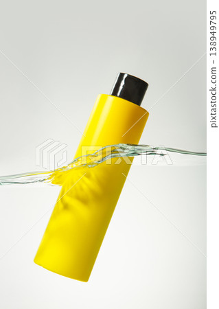 Yellow Sunscreen Bottle Crossing Clear Water Wave 138949795