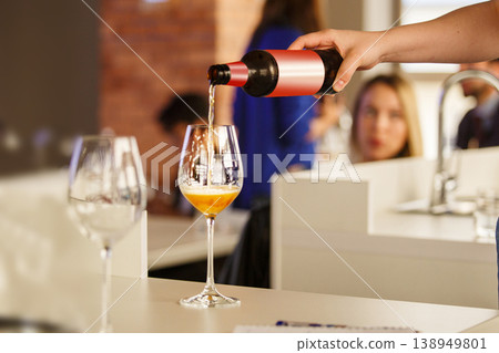 Woman Pouring Beer to Participant During Ale Type Tasting, Close up. Woman Pouring Beer to Participant During Ale Type Tasting, Close up. 138949801