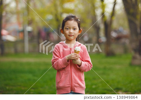 Child Asian Girl Holding Ice Cream in Park Child Asian Girl Holding Ice Cream in Park 138949864