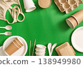 Sustainable packaging and utensils on green background 138949980