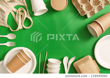 Sustainable packaging and utensils on green background Sustainable packaging and utensils on green background 138949980