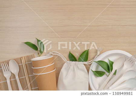 Eco-friendly tableware and reusable bag on wooden surface 138949981