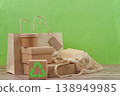Recyclable packaging and reusable bag on green background 138949985
