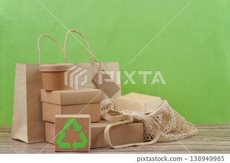 Recyclable packaging and reusable bag on green background 138949985