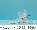 Plastic waste and shopping cart on blue background 138949989