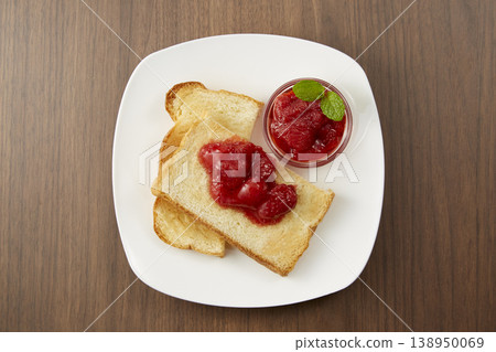 A light breakfast image of strawberry jam and toast. 138950069