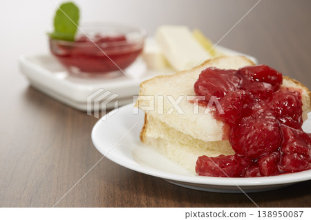 A breakfast image featuring delicious-looking strawberry confiture. 138950087