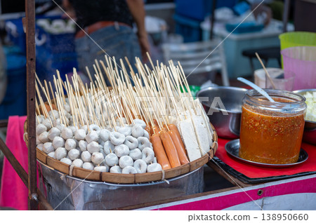 Sausages marshmallows and snacks prepared for grilling at Thai street food stall, casual outdoor cooking scene, local market atmosphere and travel food experience concept 138950660