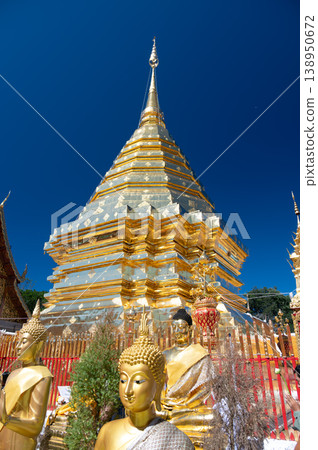 Golden stupa of Wat Phra That Doi Suthep temple in Thailand, richly decorated Buddhist structure with statues and ornate details, spiritual landmark in Chiang Mai Golden stupa of Wat Phra That Doi Suthep temple in Thailand, richly decorated Buddhist structure with statues and ornate details, spiritual landmark in Chiang Mai 138950672