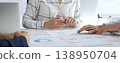 Business team meeting with financial documents and charts, discussing data analysis, planning strategies, and corporate success during collaborative teamwork session 138950704
