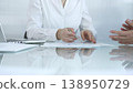 Business partners or lawyers are analyzing documents and collaborating on a project during a productive office meeting while sitting at the glass table. Businesspeople concept 138950729