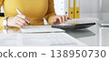 Woman calculating finance, taxes, and accounting paperwork at office desk, budgeting expenses, filing documents. Audit and taxes in business 138950730