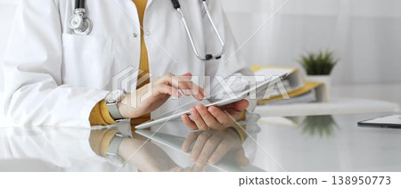 Female doctor using digital tablet, providing modern healthcare and medical technology consultation. Medicine, healthcare and science concept Female doctor using digital tablet, providing modern healthcare and medical technology consultation. Medicine, healthcare and science concept 138950773