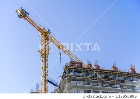 Construction of a building. Construction site with crane. Business, development, industry. 138950999