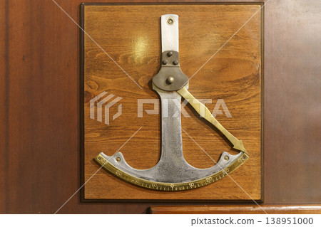 Vintage clinometer mounted on wooden panel, antique angle measuring instrument Vintage clinometer mounted on wooden panel, antique angle measuring instrument 138951000