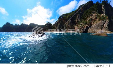 003_Iwate Prefecture: The unusual rock formations of Kitayamazaki and the wake of a small fishing boat sailing across the Pacific Ocean [September] 138951981