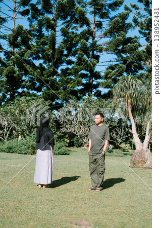 Couple standing apart in park, relationship and distance concept 138952481