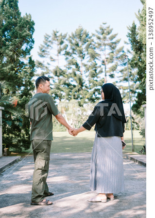 Romantic couple gaze on bridge walkway, relationship bonding concept Romantic couple gaze on bridge walkway, relationship bonding concept 138952497