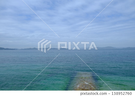 A breakwater extending into the calm waters of the Seto Inland Sea A breakwater extending into the calm waters of the Seto Inland Sea 138952760