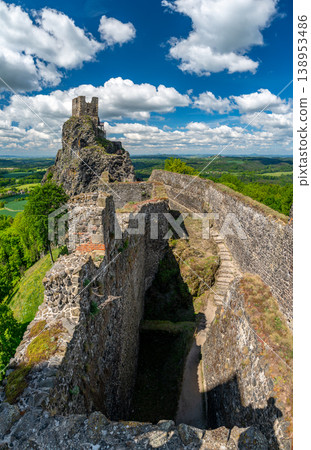 Close up view of the walls and iconic towers of Trosky Castle in Cesky Raj Czech Republic with massive stone structures rising above ruins in summer weather popular tourist destination 138953486