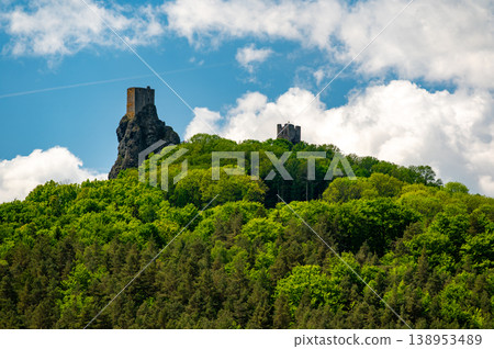 Panoramic view of Cesky Raj landscape in summer with iconic Trosky castle towers rising above green countryside under blue sky with dramatic clouds summer scenic natureview stock 138953489