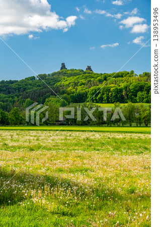 Panoramic view of Cesky Raj landscape in summer with iconic Trosky castle towers rising above green countryside under blue sky with dramatic clouds summer scenic natureview stock 138953496