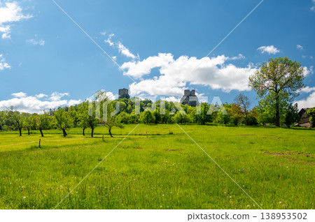 Panoramic view of Cesky Raj landscape in summer with iconic Trosky castle towers rising above green countryside under blue sky with dramatic clouds summer scenic natureview stock 138953502