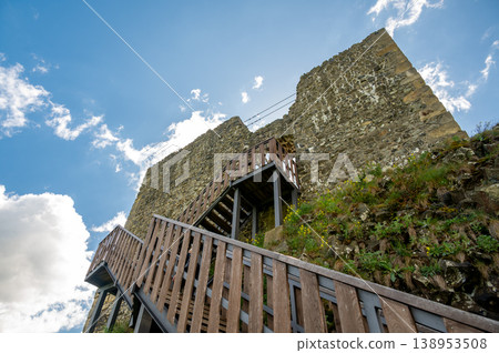 Close up view of the walls and iconic towers of Trosky Castle in Cesky Raj Czech Republic with massive stone structures rising above ruins in summer weather popular tourist destination 138953508