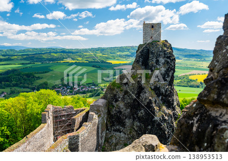 Close up view of the walls and iconic towers of Trosky Castle in Cesky Raj Czech Republic with massive stone structures rising above ruins in summer weather popular tourist destination 138953513