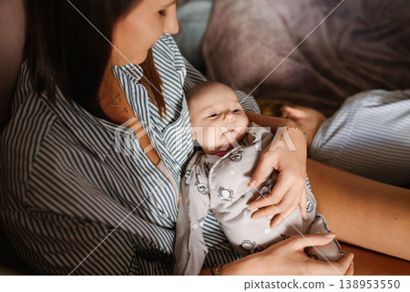Mother Holding Newborn Baby In Cozy Bedroom Mother Holding Newborn Baby In Cozy Bedroom 138953550