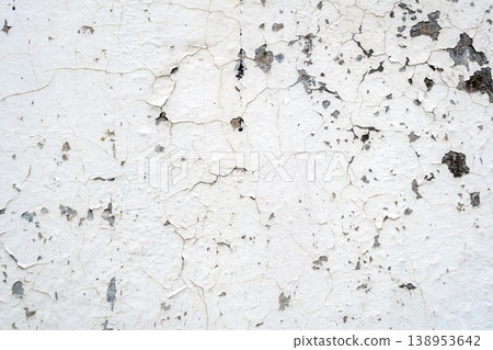 Cracked texture of an old wall with peeling paint Cracked texture of an old wall with peeling paint 138953642