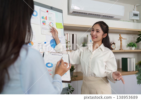Businesswomen collaborating on financial presentation Businesswomen collaborating on financial presentation 138953689