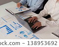 Collaborative data analysis with laptops and charts in an office 138953692