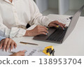 Professional using laptop for financial analysis 138953704