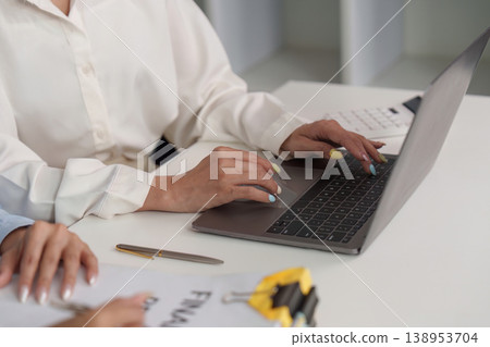 Professional using laptop for financial analysis Professional using laptop for financial analysis 138953704