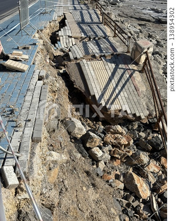 Collapsed stone retaining wall with exposed rubble and debris in outdoor setting Collapsed stone retaining wall with exposed rubble and debris in outdoor setting 138954302