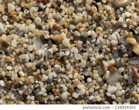 Pebbles and small stones create textured natural background with vibrant earth tones 138954305