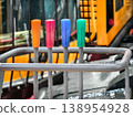 Control levers in bright colors on construction equipment at a busy work site during the day 138954928