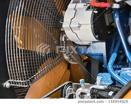 Close view of a truck engine showing components and assembly in a garage setting during daytime 138954929