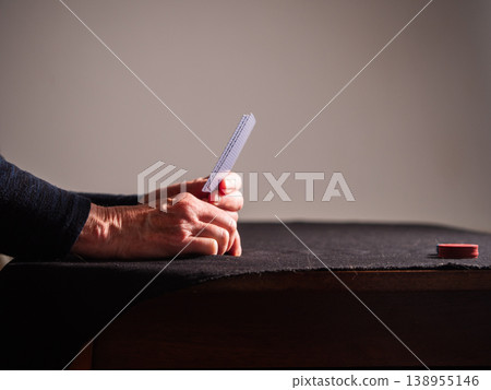 Hands holding playing cards at a poker game 138955146