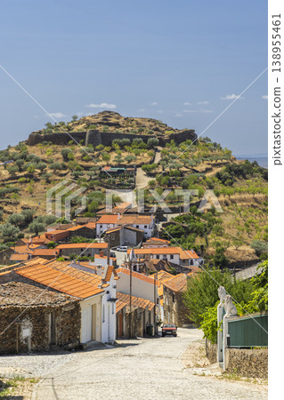 Traditional village houses leading to ancient fort ruins in Vila Nova de Foz Coa Traditional village houses leading to ancient fort ruins in Vila Nova de Foz Coa 138955461