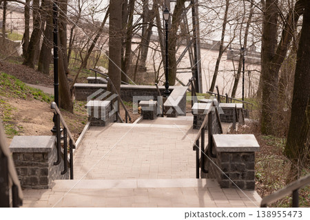 Stone Staircase with Black Metal Handrails and Street Lamps in a Quiet Spring Park Stone Staircase with Black Metal Handrails and Street Lamps in a Quiet Spring Park 138955473