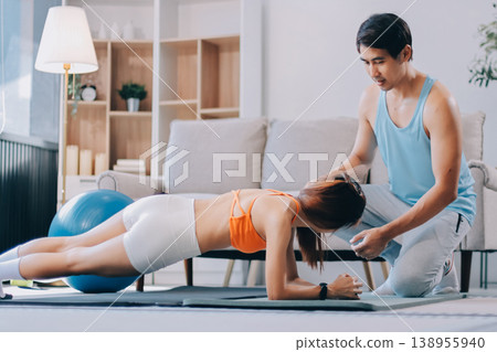 Support, teamwork and fitness couple doing workout training, challenging exercise for endurance, strength and stamina in a gym. Active, fit man and woman giving support and motivation during pushup Support, teamwork and fitness couple doing workout training, challenging exercise for endurance, strength and stamina in a gym. Active, fit man and woman giving support and motivation during pushup 138955940