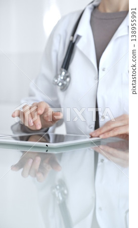 Doctor person using digital tablet, providing modern medical consultation and health insurance support information. Medicine and health care 138955991