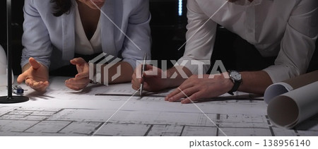 Architects and engineers working as a team, discussing architectural plans and schematics. Professional meeting focused on engineering design and project development 138956140