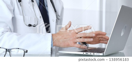 Doctor discussing medical information during an online consultation via teleconference, providing remote healthcare service. Medicine, healthcare and science concept 138956183