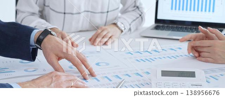 Business people having a financial meeting, discussing company strategy, reviewing data analysis, and planning future growth using charts and reports Business people having a financial meeting, discussing company strategy, reviewing data analysis, and planning future growth using charts and reports 138956676