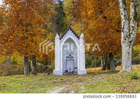 Wayside shrine with virgin Mary statue in autumn colors 138956691